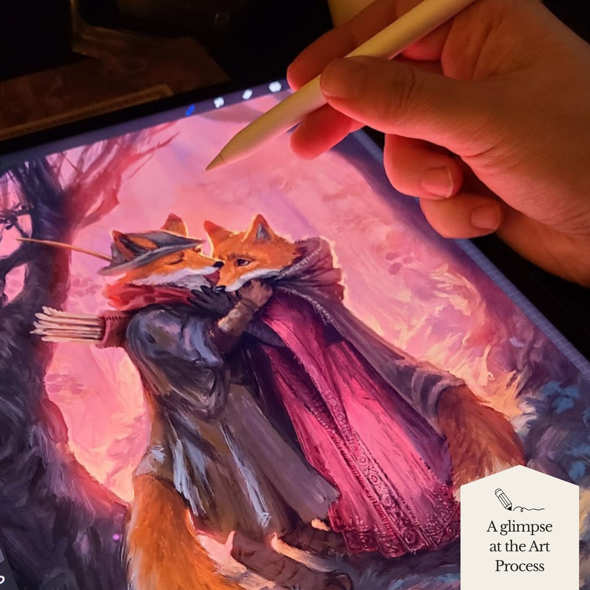 A close-up of a hand holding a stylus over a tablet displaying a colorful digital painting of two foxes embracing in a fantasy forest scene. A small badge in the lower right reads 'A glimpse at the Art Process'.
