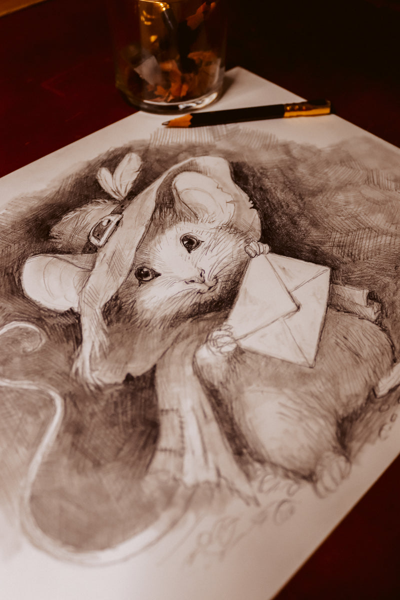A detailed pencil sketch of a small mouse wearing a hat and holding an envelope, drawn on white paper with a pencil and a glass bottle nearby on a dark surface.